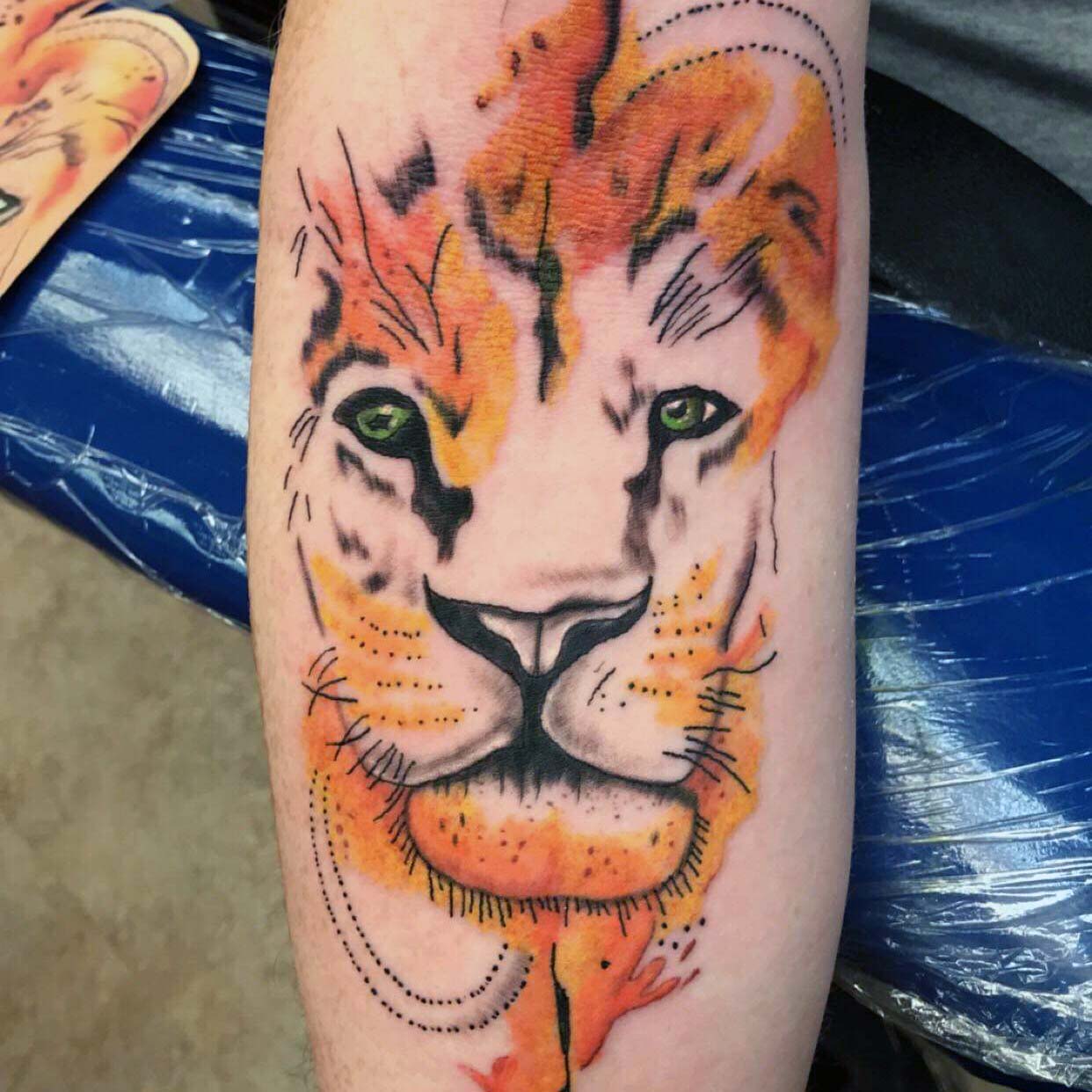 Watercolor Lion Tattoo by Reinkcarnated Tattoo Studio in Vermont
